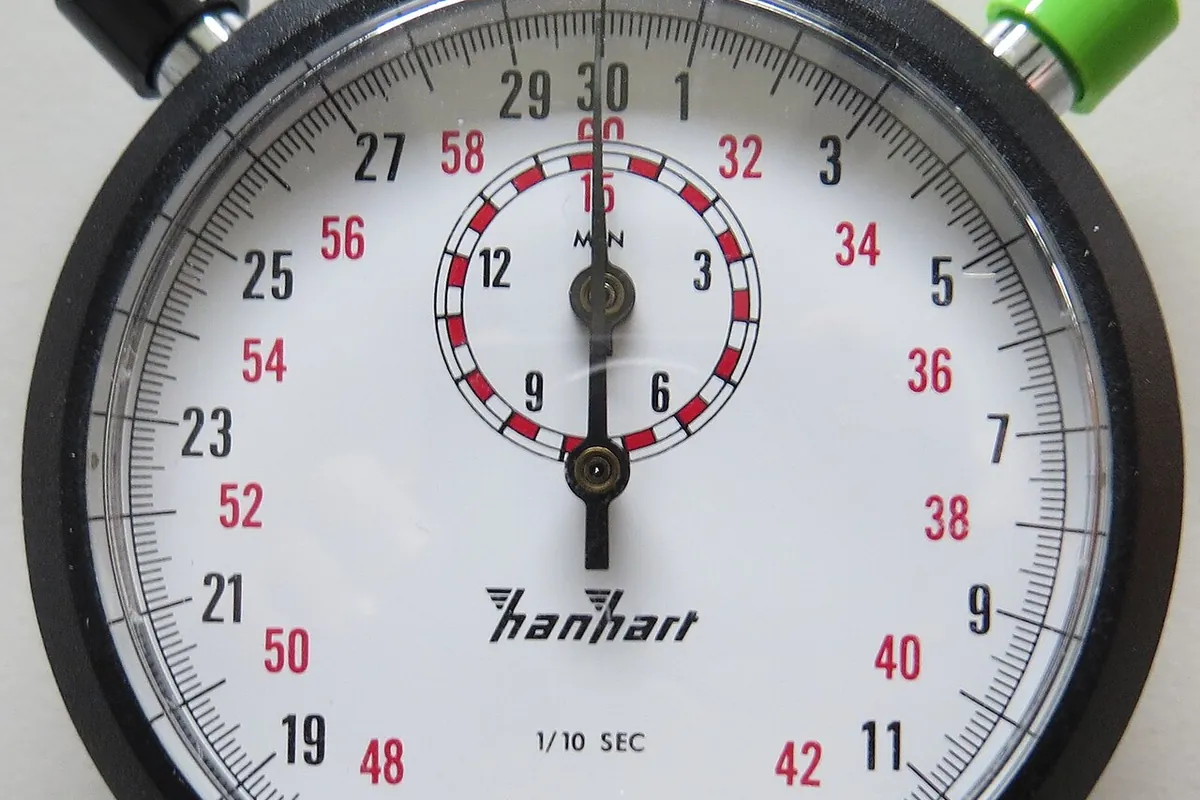 Close view of a Hanhart mechanical stopwatch with a white dial and three coloured push-buttons.